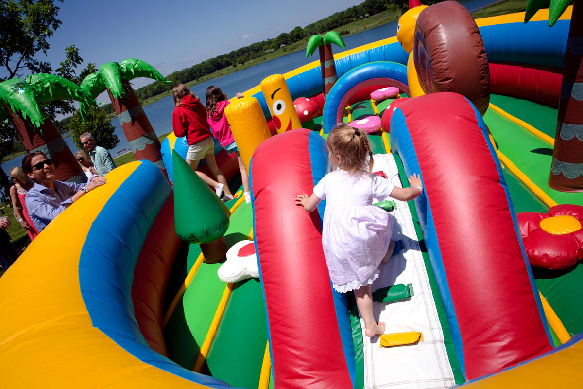 Kids playing in bounce house slide at Independence Grove