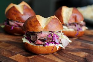 Graduation party catering sirloin and slaw sandwich on a pretzel bun